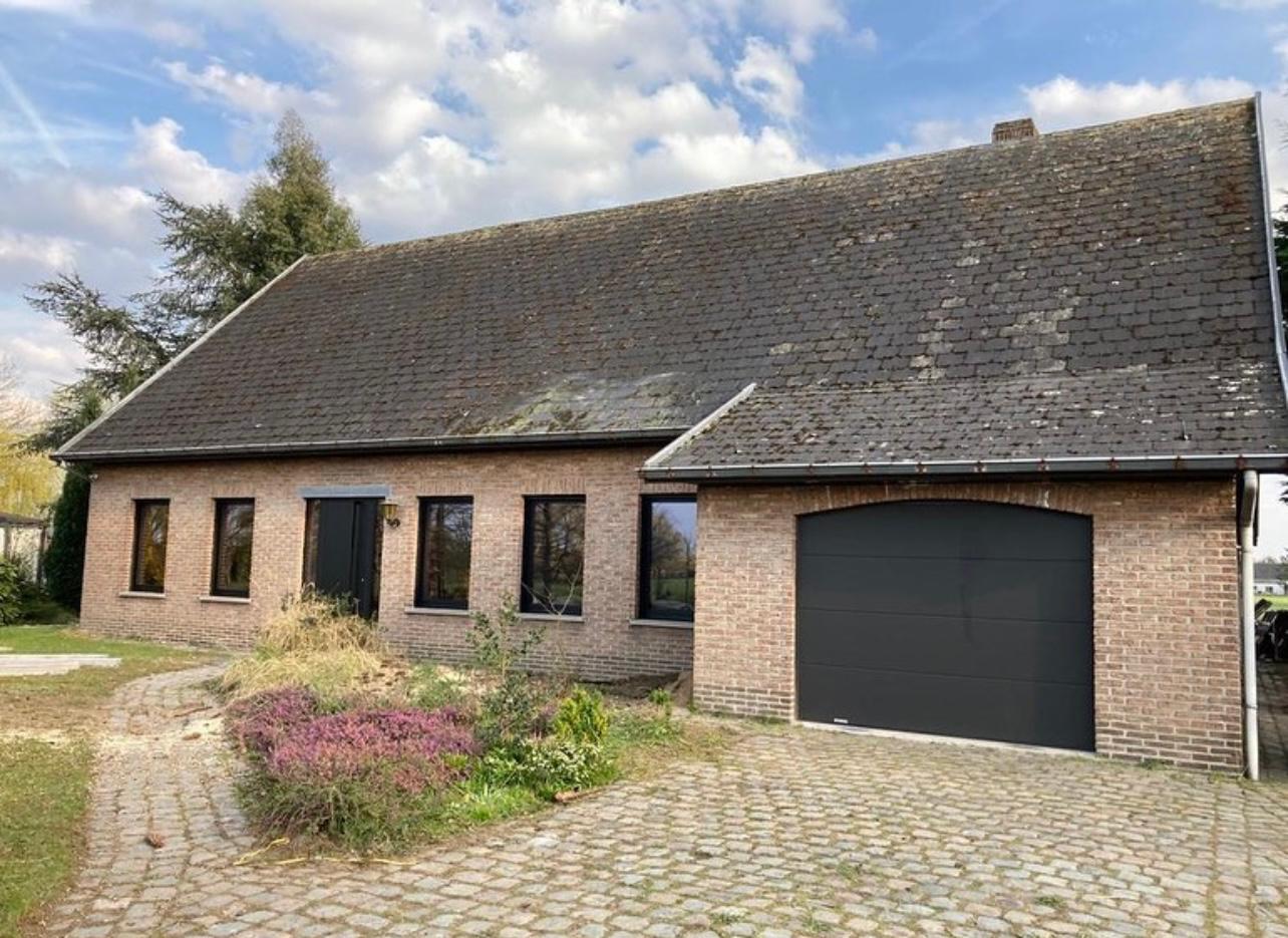 Woning met sterk verouderd en vermost leien dak voor de renovatie