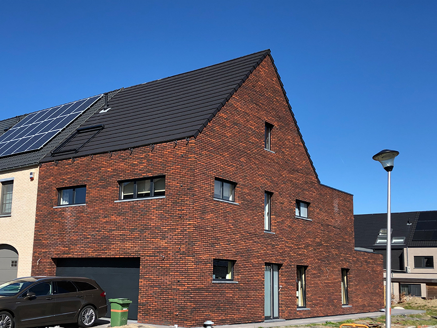 Gevel afgewerkt met roodbruine steenstrips op geïsoleerde buitenmuur