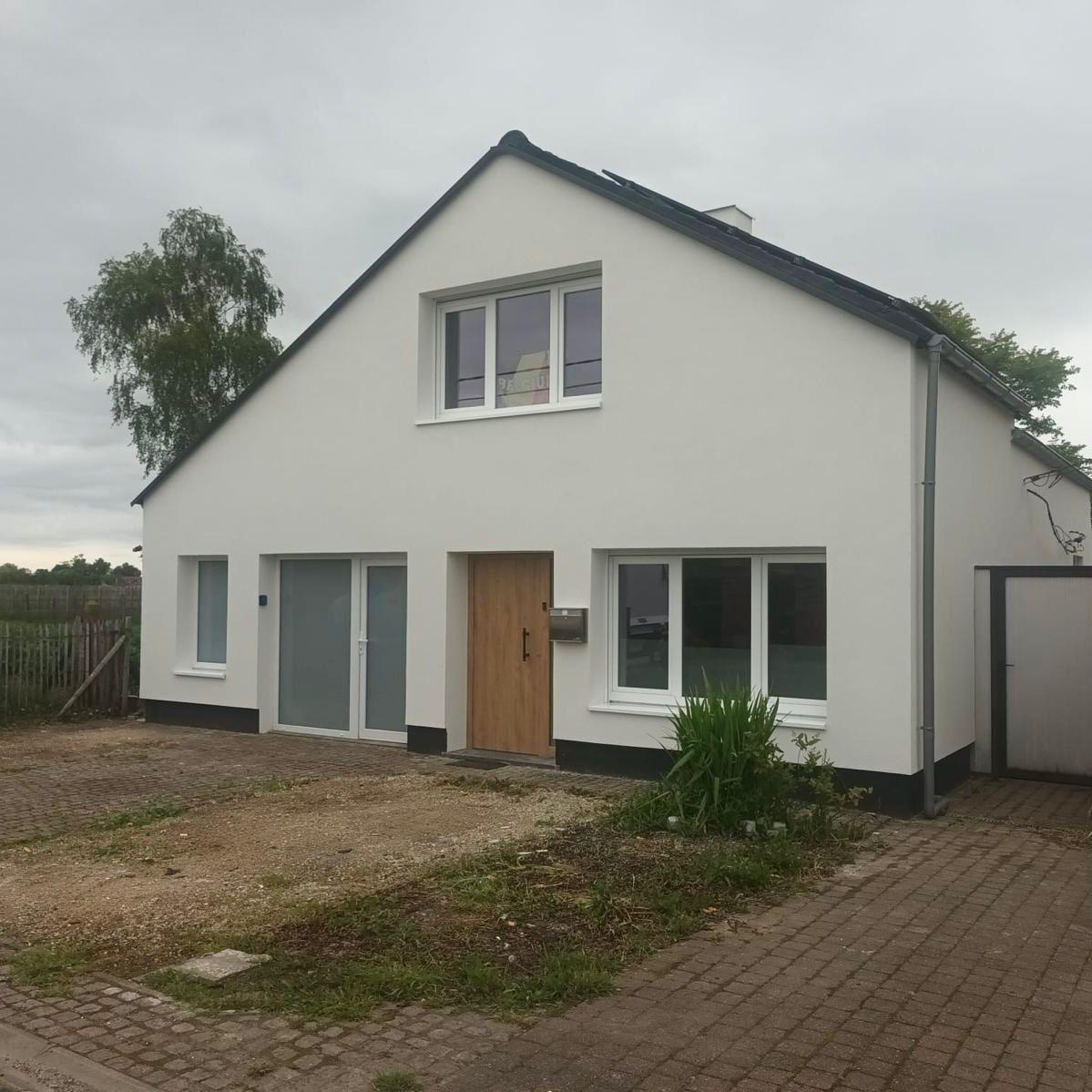 Woning met volledig geïsoleerde en met witte crepi afgewerkte gevel, gerealiseerd door Enervea